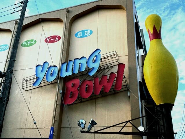A giant bowling pin towering over the street